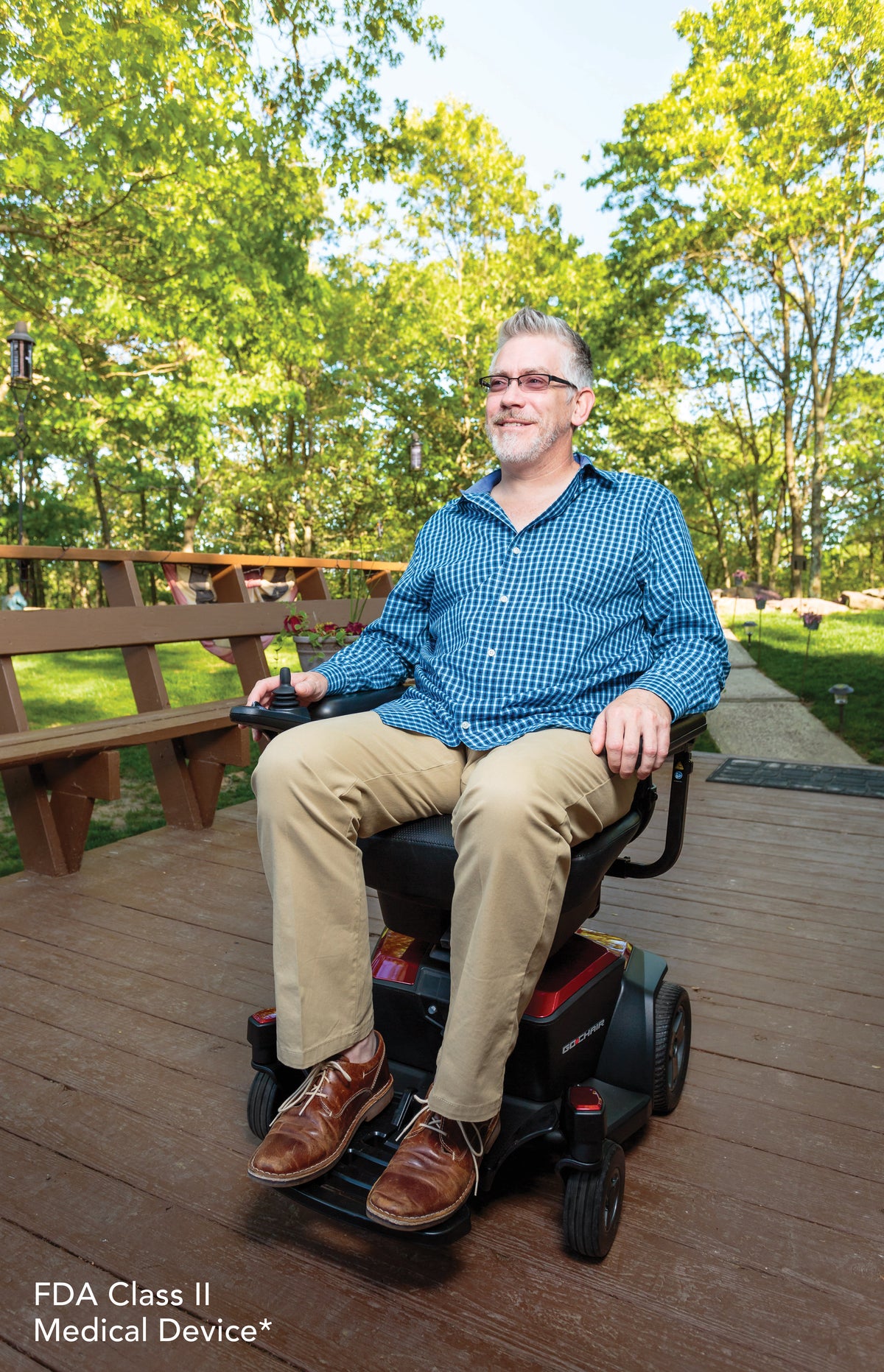 Pride Go-Chair power wheelchair, lifestyle - man riding outdoors