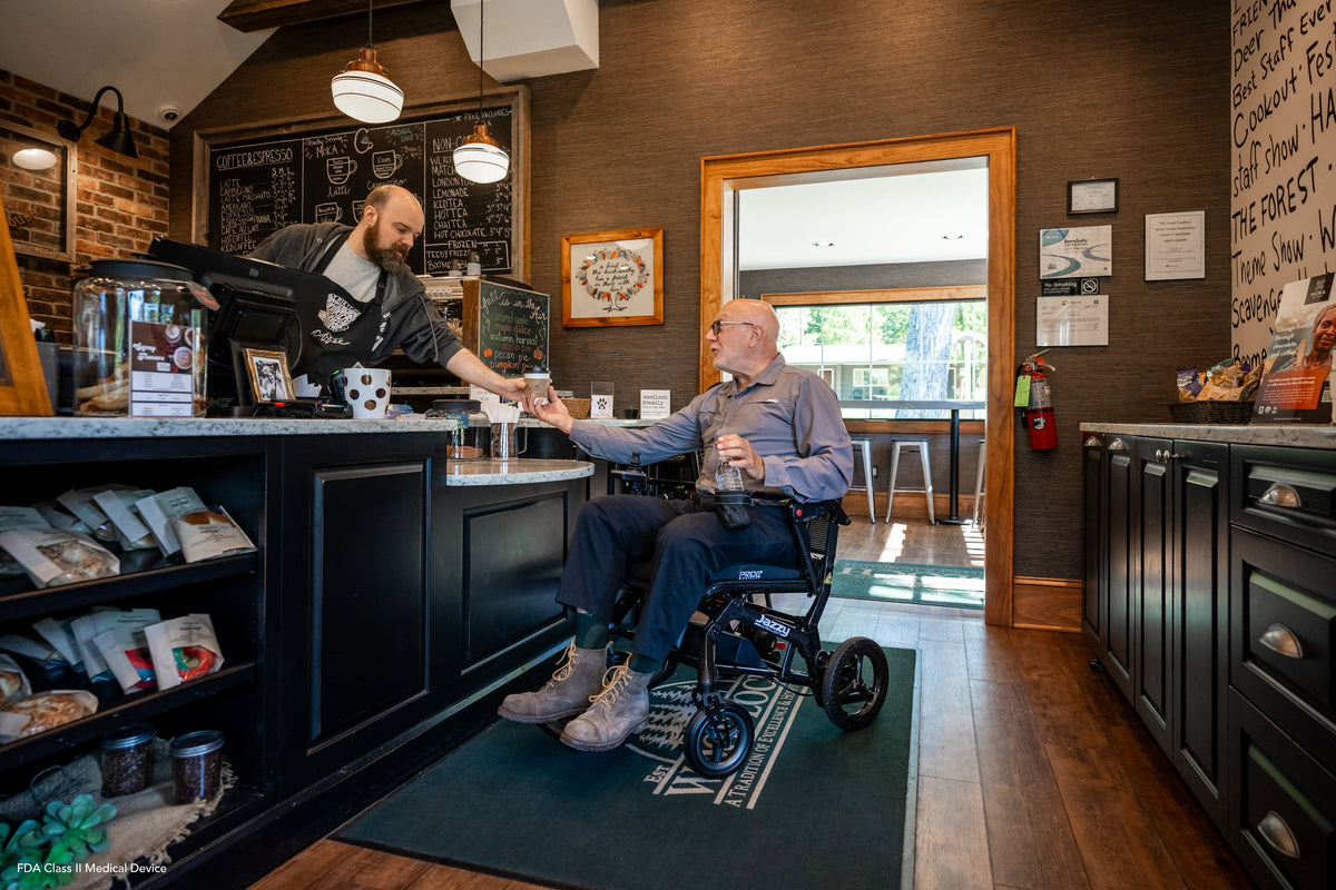 Pride Jazzy Ultra Light power wheelchair, lifestyle - person using chair at a coffee shop