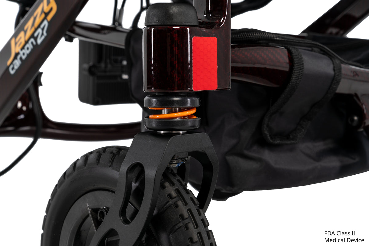 Pride Jazzy Carbon 27 power wheelchair, suspension close-up, black cherry