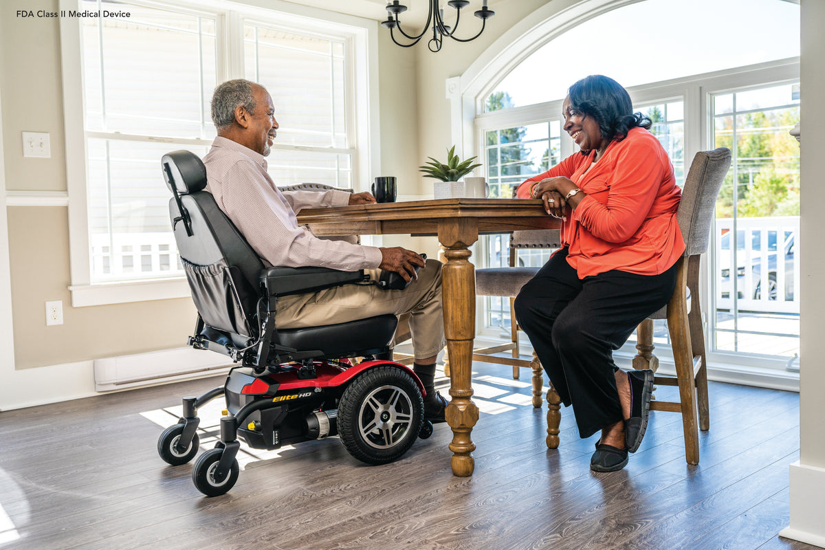 Pride Jazzy Elite HD power wheelchair, lifestyle - person using chair at kitchen table